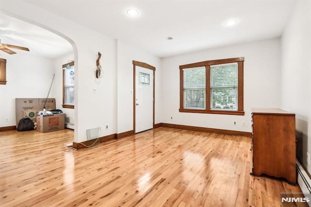 12-67 12th St, Fair Lawn, NJ 07410 - unfurnished living room with arched walkways, light wood-style floors, ceiling fan, baseboards, and recessed lighting
