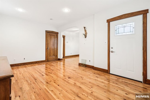 12-67 12th St, Fair Lawn, NJ 07410 - foyer entrance featuring arched walkways, baseboards, light wood-type flooring, and recessed lighting