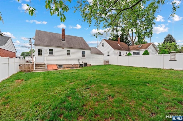 59 Harrison Ave, Saddle Brook, NJ 07663 - rear view of house with a chimney and central AC unit