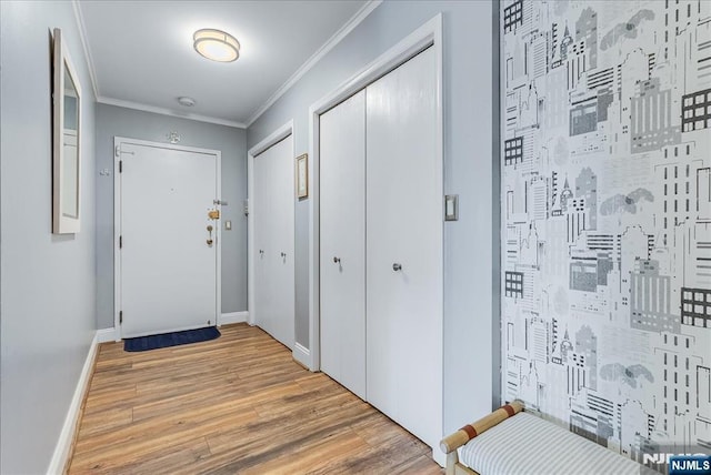 doorway to outside with light wood-style flooring, crown molding, and baseboards