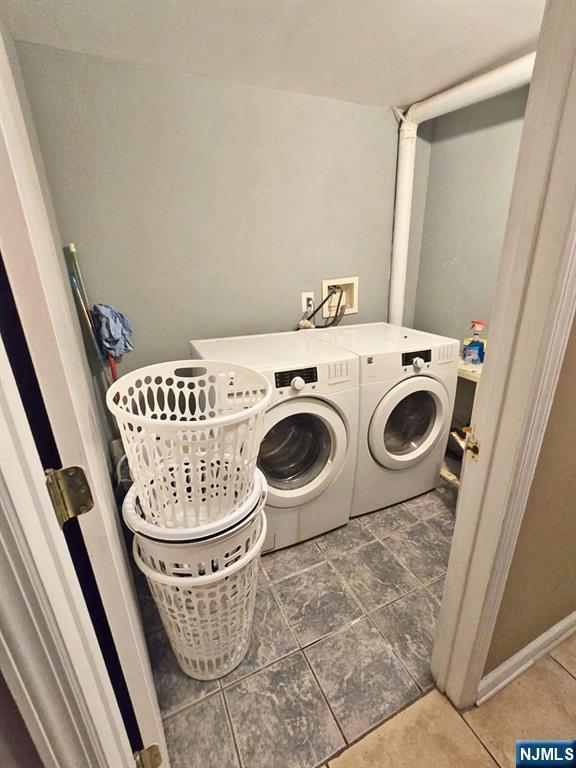 clothes washing area with washer and dryer