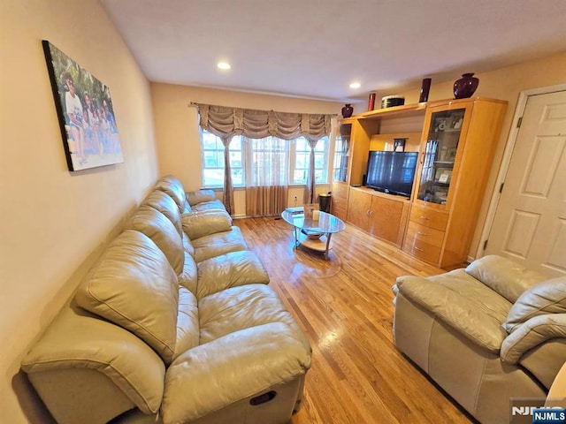 living room with light wood finished floors and recessed lighting