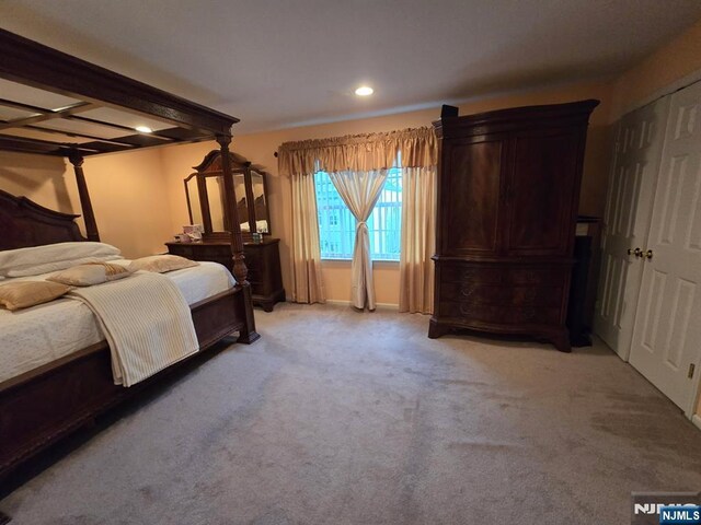 bedroom with light carpet and recessed lighting