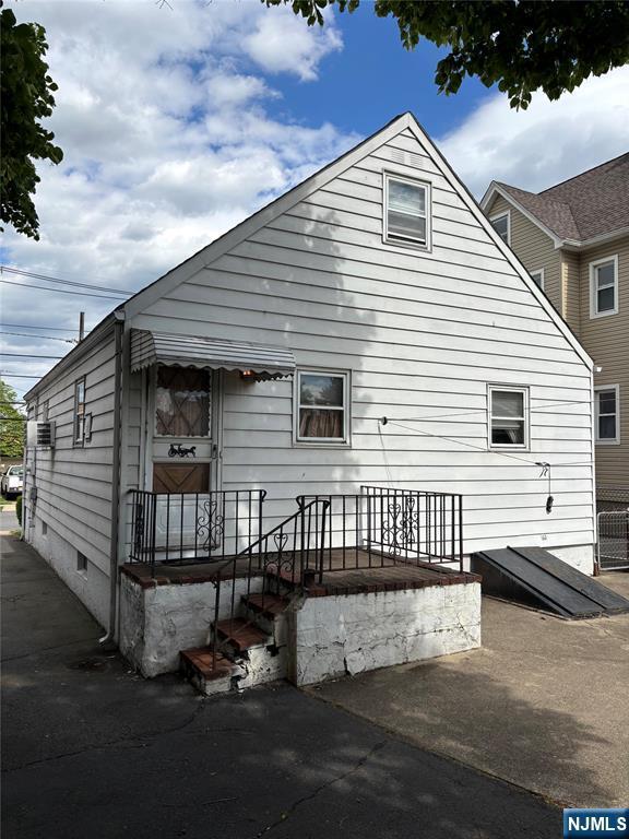 rear view of house with central air condition unit