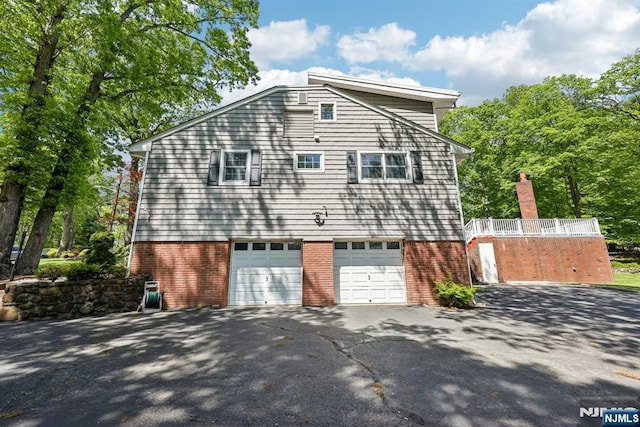 20 Old Farm Rd, Caldwell, NJ 07006 - view of property exterior featuring driveway, a garage, and brick siding