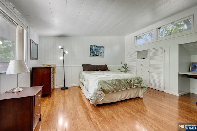 20 Old Farm Rd, Caldwell, NJ 07006 - bedroom featuring multiple windows, light wood-type flooring, and a decorative wall