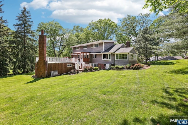 20 Old Farm Rd, Caldwell, NJ 07006 - back of property featuring a chimney, a yard, a deck, stairs, and a sunroom