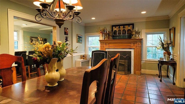 tiled dining space with ornamental molding, a chandelier, a fireplace, baseboards, and recessed lighting