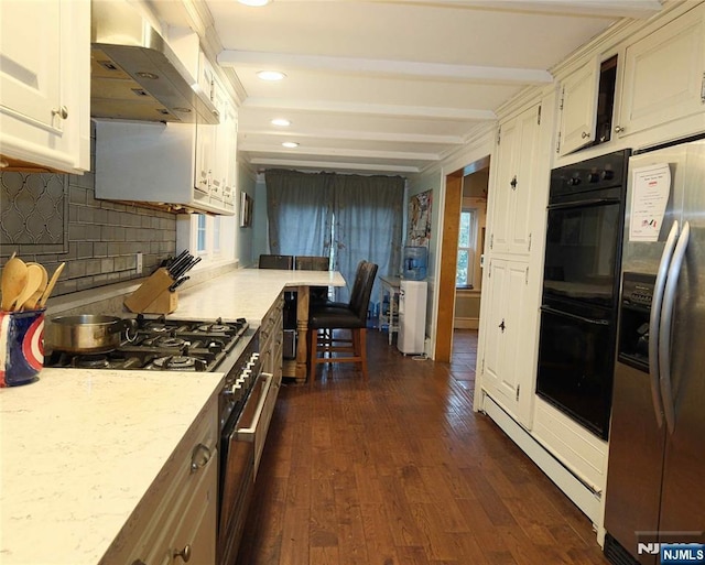 kitchen featuring appliances with stainless steel finishes, wall chimney range hood, decorative backsplash, dark wood-style flooring, and beamed ceiling