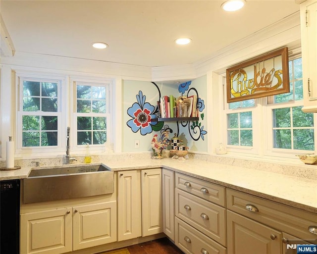 kitchen featuring a sink, dishwasher, light stone counters, recessed lighting, and ornamental molding