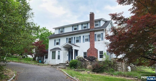 view of front facade featuring a chimney