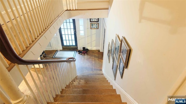 staircase with wood finished floors