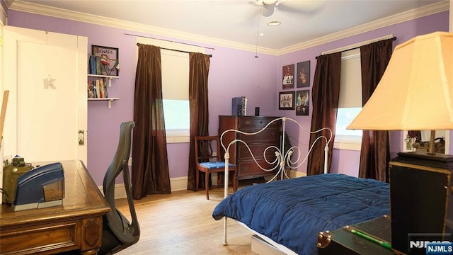 bedroom with ornamental molding, wood finished floors, and baseboards