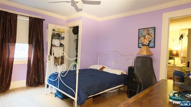 bedroom featuring wood finished floors, crown molding, ceiling fan, and baseboards
