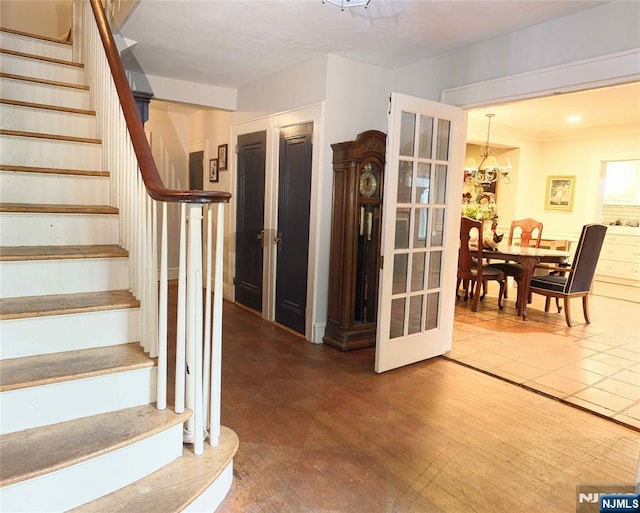 stairway with a chandelier