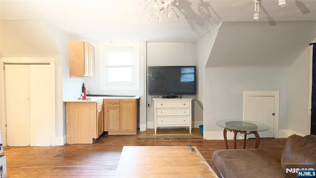 living room with dark wood-type flooring and baseboards