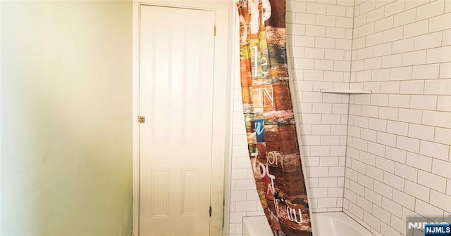 full bath featuring shower / tub combo with curtain