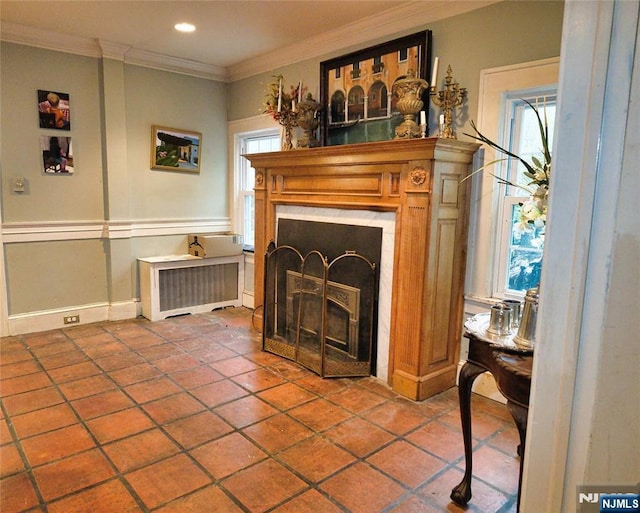 tiled living room featuring a fireplace, radiator heating unit, crown molding, plenty of natural light, and recessed lighting