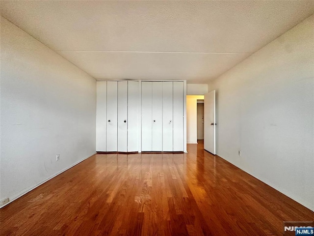 250 Gorge Unit 23A, Cliffside Park, NJ 07010 - unfurnished bedroom with wood finished floors and multiple closets