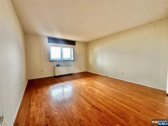 250 Gorge Unit 23A, Cliffside Park, NJ 07010 - spare room with hardwood / wood-style flooring, baseboards, and radiator