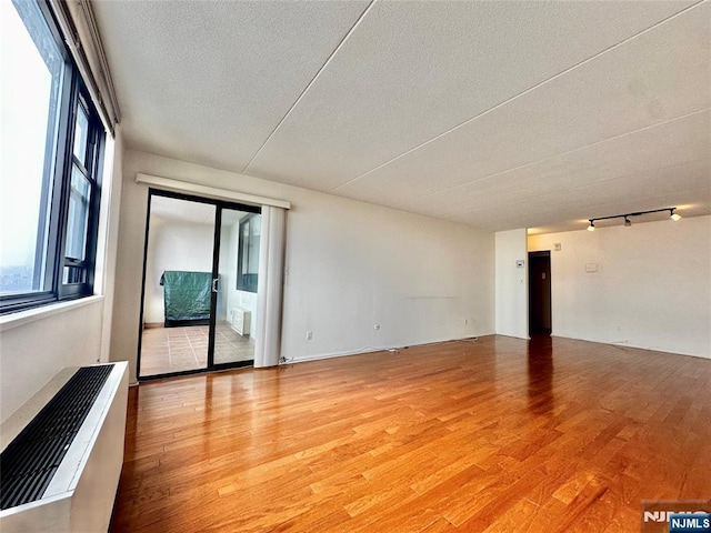 250 Gorge Unit 23A, Cliffside Park, NJ 07010 - empty room with light wood-style floors and a textured ceiling