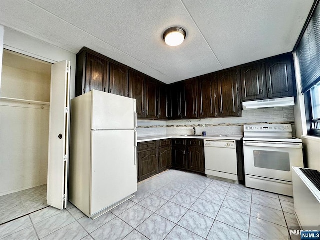 250 Gorge Unit 23A, Cliffside Park, NJ 07010 - kitchen featuring white appliances, under cabinet range hood, a sink, light countertops, and dark brown cabinets
