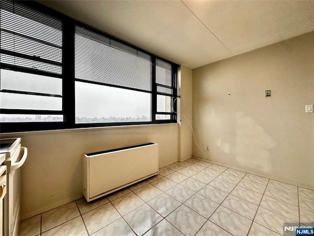 250 Gorge Unit 23A, Cliffside Park, NJ 07010 - empty room with radiator and light tile patterned flooring