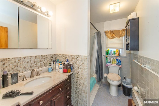 full bathroom featuring tile walls, tile patterned flooring, toilet, shower / bathtub combination with curtain, and vanity