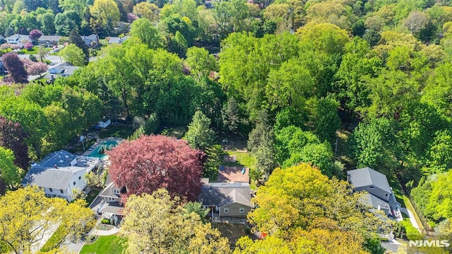aerial view of residential area with a heavily wooded area