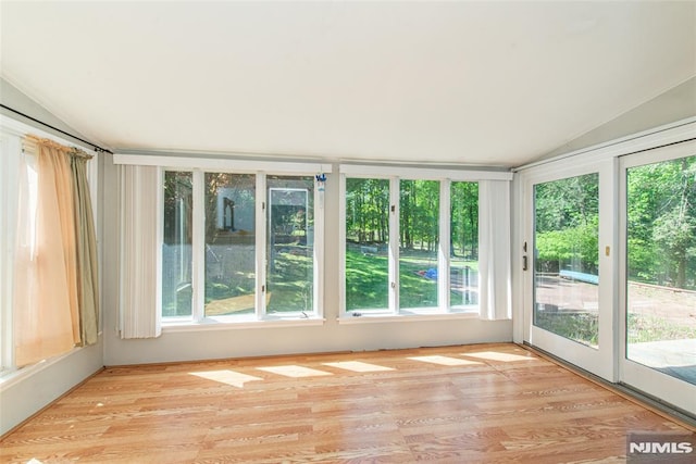 unfurnished sunroom with lofted ceiling and wood finished floors
