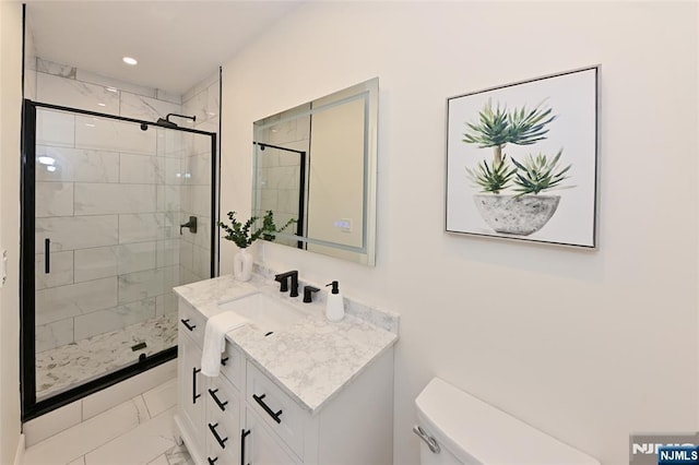 bathroom with marble look tiles, a shower stall, toilet, vanity, and recessed lighting