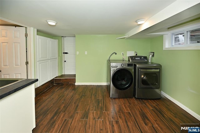 laundry area featuring washer and dryer, baseboards, and dark wood-style flooring