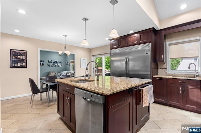 kitchen with appliances with stainless steel finishes, a sink, light tile patterned floors, and recessed lighting
