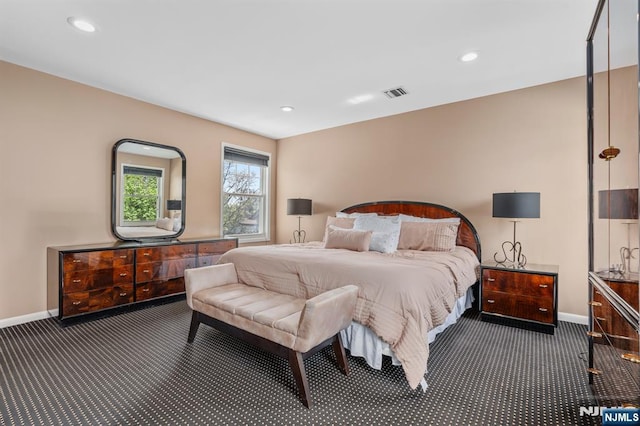 bedroom featuring dark carpet, baseboards, and recessed lighting