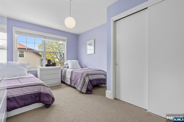 bedroom with carpet flooring and a closet