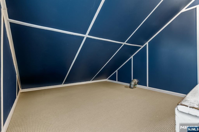 bonus room featuring carpet, baseboards, and vaulted ceiling