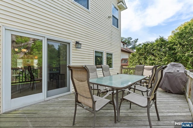 wooden deck with outdoor dining space