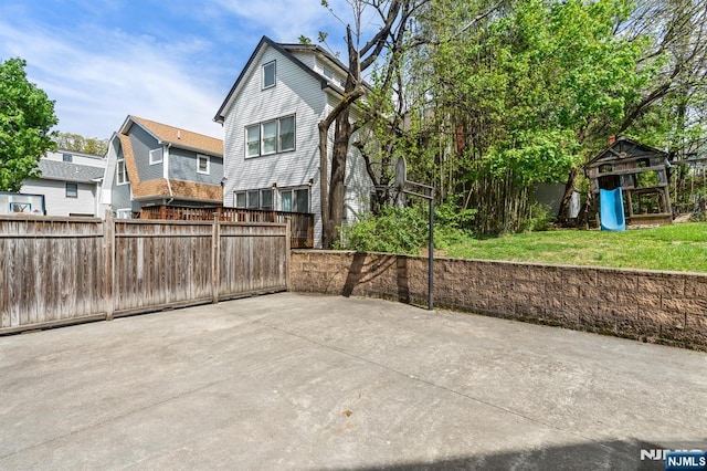 back of house featuring a patio area and a playground