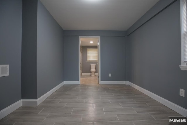 bonus room featuring wood finish floors and baseboards