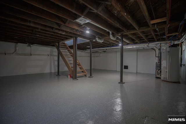 below grade area featuring water heater and stairs