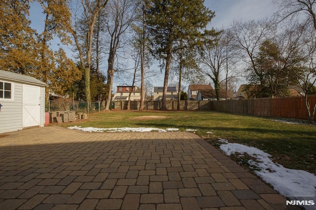 view of patio with an outdoor structure and a shed