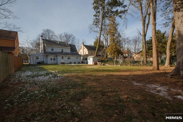 view of yard with a shed and an outbuilding