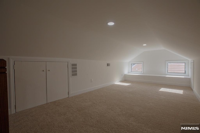 bonus room featuring lofted ceiling, light carpet, recessed lighting, and baseboards