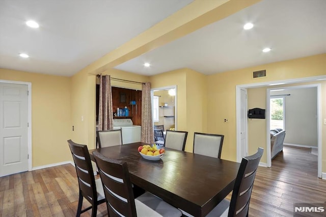 dining space featuring washer / clothes dryer, hardwood / wood-style flooring, recessed lighting, and baseboards