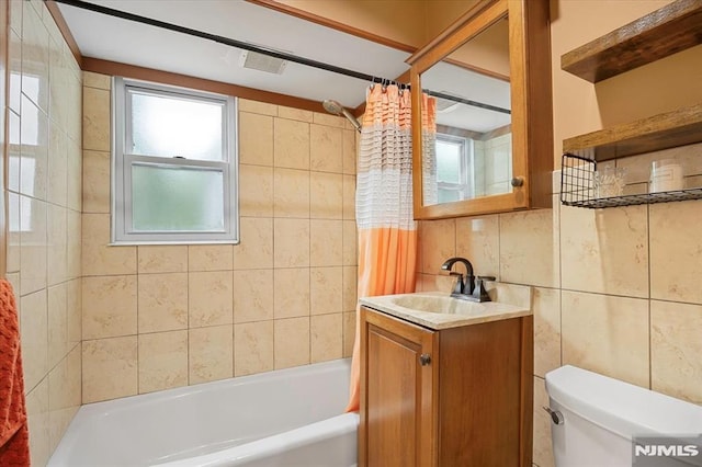 bathroom featuring tile walls, shower / bath combo, toilet, tasteful backsplash, and vanity