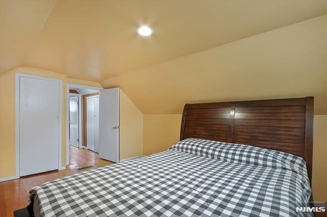 bedroom featuring vaulted ceiling and light wood finished floors