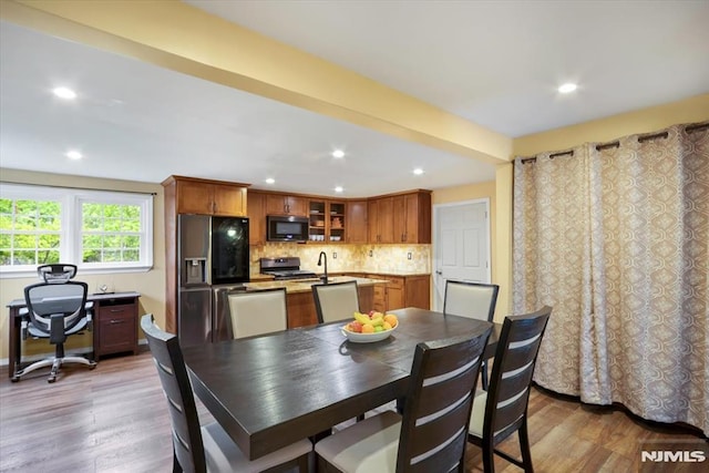 dining area featuring wood finished floors, recessed lighting, and a desk