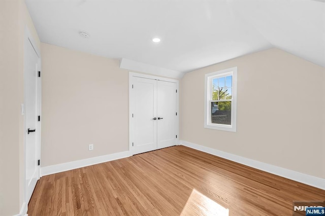 bonus room featuring light wood-style floors, baseboards, lofted ceiling, and recessed lighting