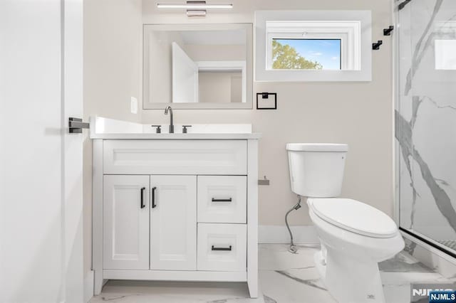 full bathroom featuring marble finish flooring, a marble finish shower, toilet, and vanity
