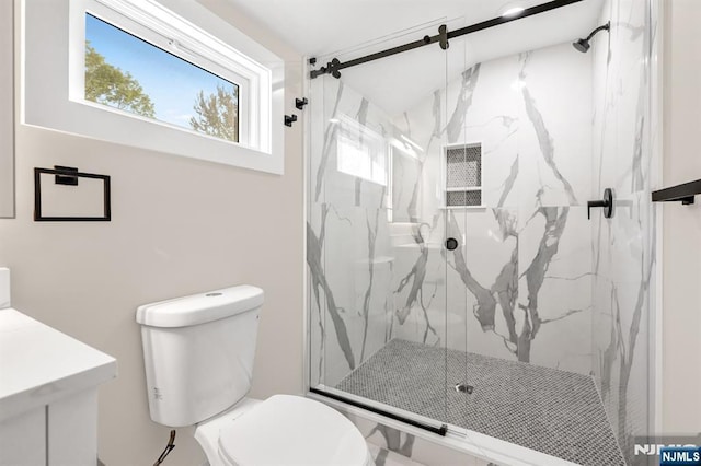 full bathroom with a marble finish shower and toilet